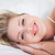 Pretty woman smiling while she is resting on her bed stock photo © wavebreak_media