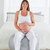 Pretty pregnant female caressing her belly while sitting on a gym ball in her bedroom stock photo © wavebreak_media