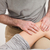 Physiotherapist massaging the knee of a woman in a room stock photo © wavebreak_media
