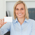 Blonde businesswoman holding a card looking into camera in her office stock photo © wavebreak_media