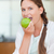 Portrait of a woman eating an apple in her kitchen stock photo © wavebreak_media