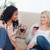 Two women are talking and sitting up against a couch drinking wine stock photo © wavebreak_media