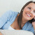Smiling woman lying on sofa and calling in the living groom stock photo © wavebreak_media