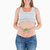 Beautiful pregnant woman holding a broccoli while standing against a white background stock photo © wavebreak_media
