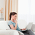 Pensive woman relaxing with her laptop while sitting on a sofa in the living room stock photo © wavebreak_media