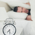 Portrait of a man covering his ears with a pillow while his alarm clock is ringing stock photo © wavebreak_media
