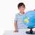 Smiling boy posing with a globe against a white background stock photo © wavebreak_media