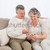 Smiling couple petting their gringer cat on the couch stock photo © wavebreak_media