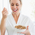 Smiling woman in bathrobe having cereal stock photo © wavebreak_media