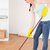 Good looking red-haired woman sweeping the floor at home stock photo © wavebreak_media