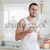 Happy man having breakfast in his kitchen stock photo © wavebreak_media