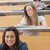 Student sitting reading a book while smiling in lecture hall stock photo © wavebreak_media