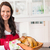 Smiling woman holding roast turkey stock photo © wavebreak_media