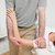 Physiotherapist pressing the shoulder of a woman in a medical room stock photo © wavebreak_media