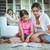 Mother and daughter sitting on the floor and looking at photo album stock photo © wavebreak_media