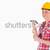 Beautiful woman holding a hammer while standing against a white background stock photo © wavebreak_media