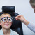 Female optometrist examining young patient with phoropter stock photo © wavebreak_media