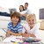 Children painting in living-room and parents on sofa stock photo © wavebreak_media