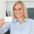 Blonde businesswoman holding a card in her office stock photo © wavebreak_media