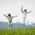 Boy and girl running and jumping on spring field in Alps stock photo © zurijeta