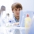 Young male scientist in lab with laptop, white environment stock photo © zurijeta