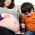 Angry son on his new brother or sister - pregnant mother, funny scene stock photo © zurijeta