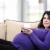 happy pregnant woman on couch stock photo © zurijeta
