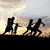 Silhouette, group of happy children playing on meadow, sunset, summertime stock photo © zurijeta